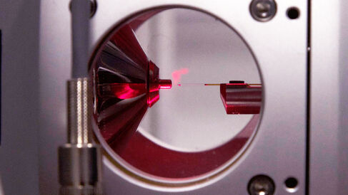 Gas-phase ions being generated in a nano-electrospray ion source.